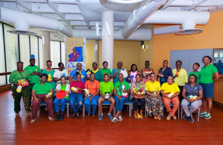 A picture of a group of women and men holds crocheted products